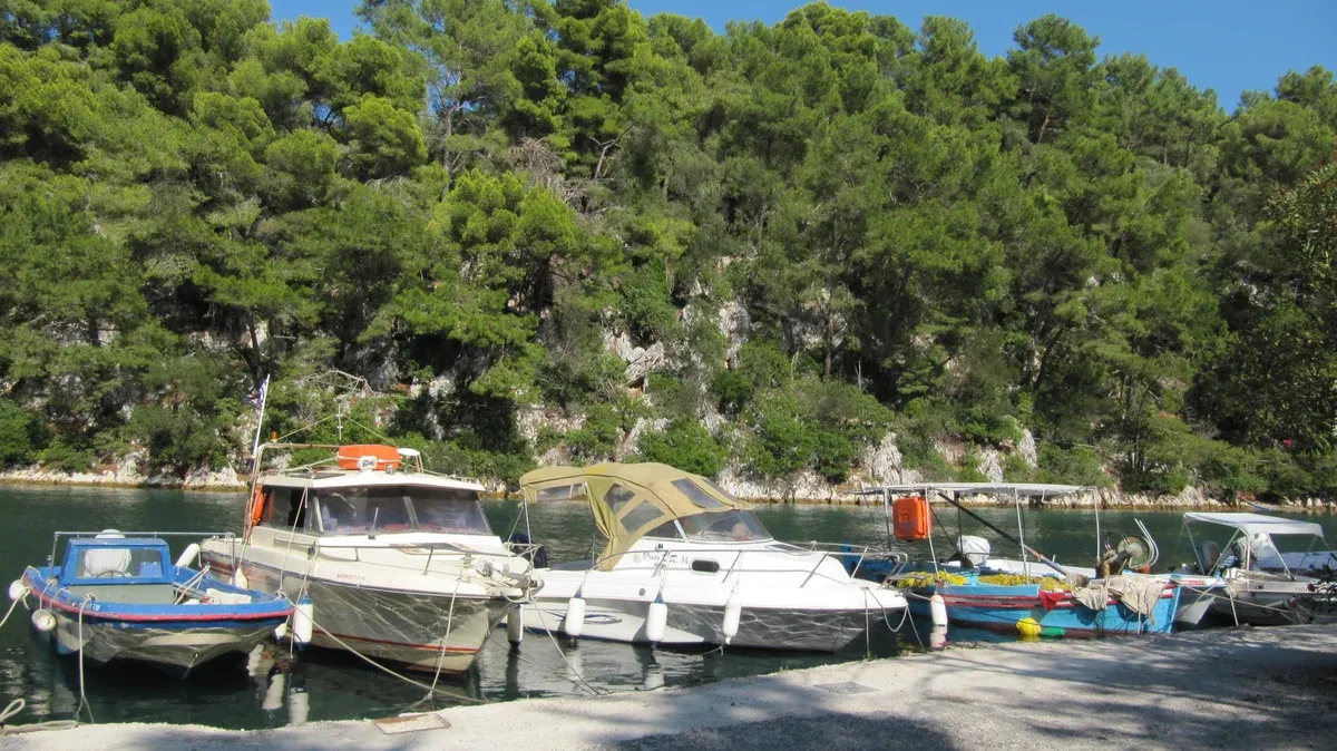 Motor boats moored in the green harbour of Gaios on Paxos, the port the Corfu boat tour days stop at